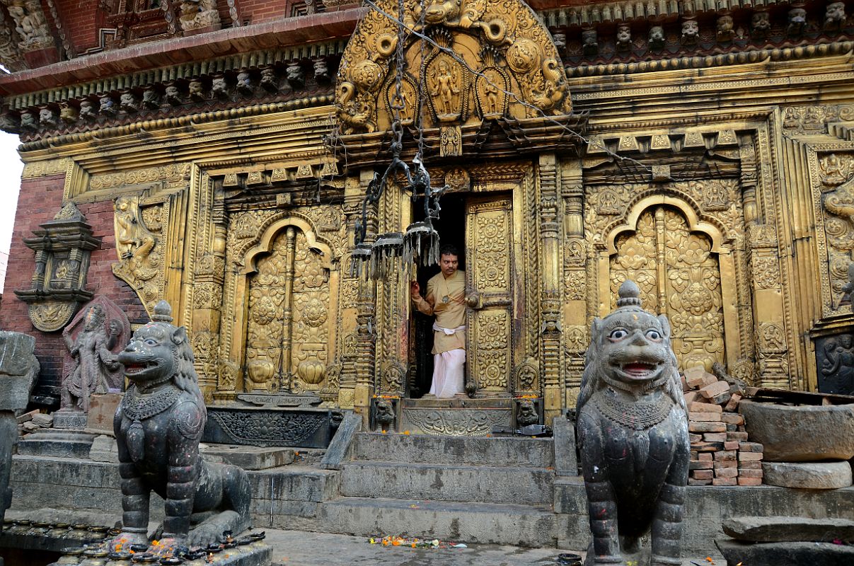 Kathmandu Changu Narayan 17 Changu Narayan Temple Main Entrance Has Beautiful Gilded Doors And Windows And Two Snow Lions Two snow lions guard the main entrance to the Changu Narayan Temple which has a beautifully gilded door and windows.